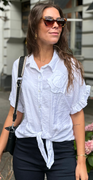 Uma bluse med bindebånd og broderet blomst foran hvid LikeLondon